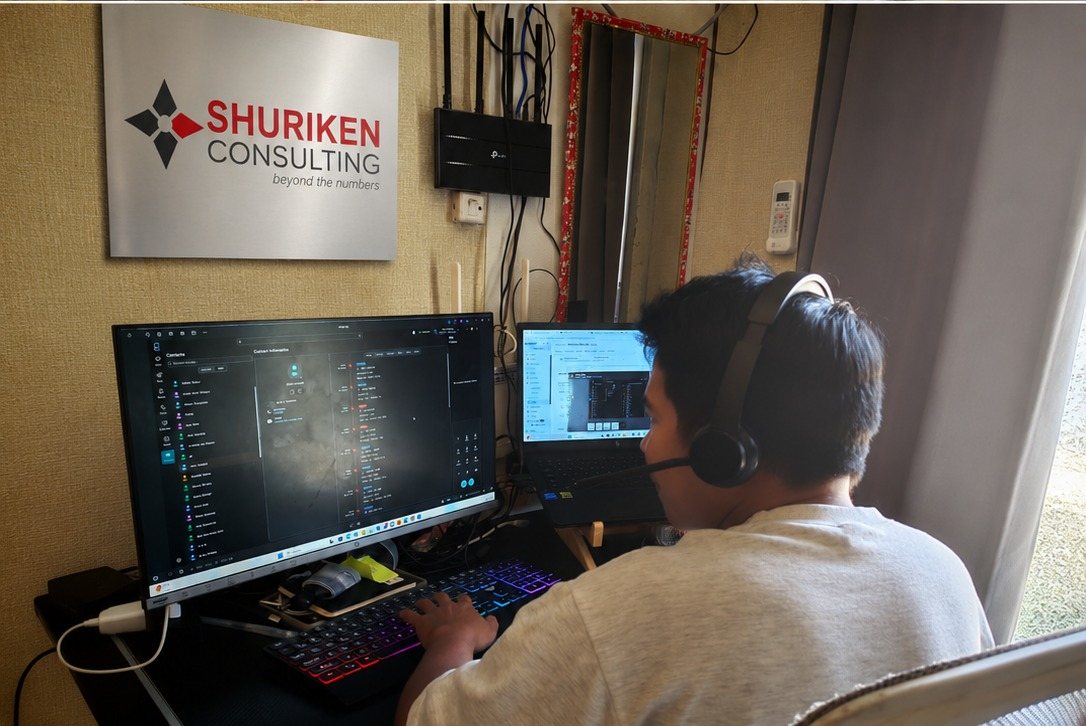 A Shuriken Consulting team member on a headset at their desk